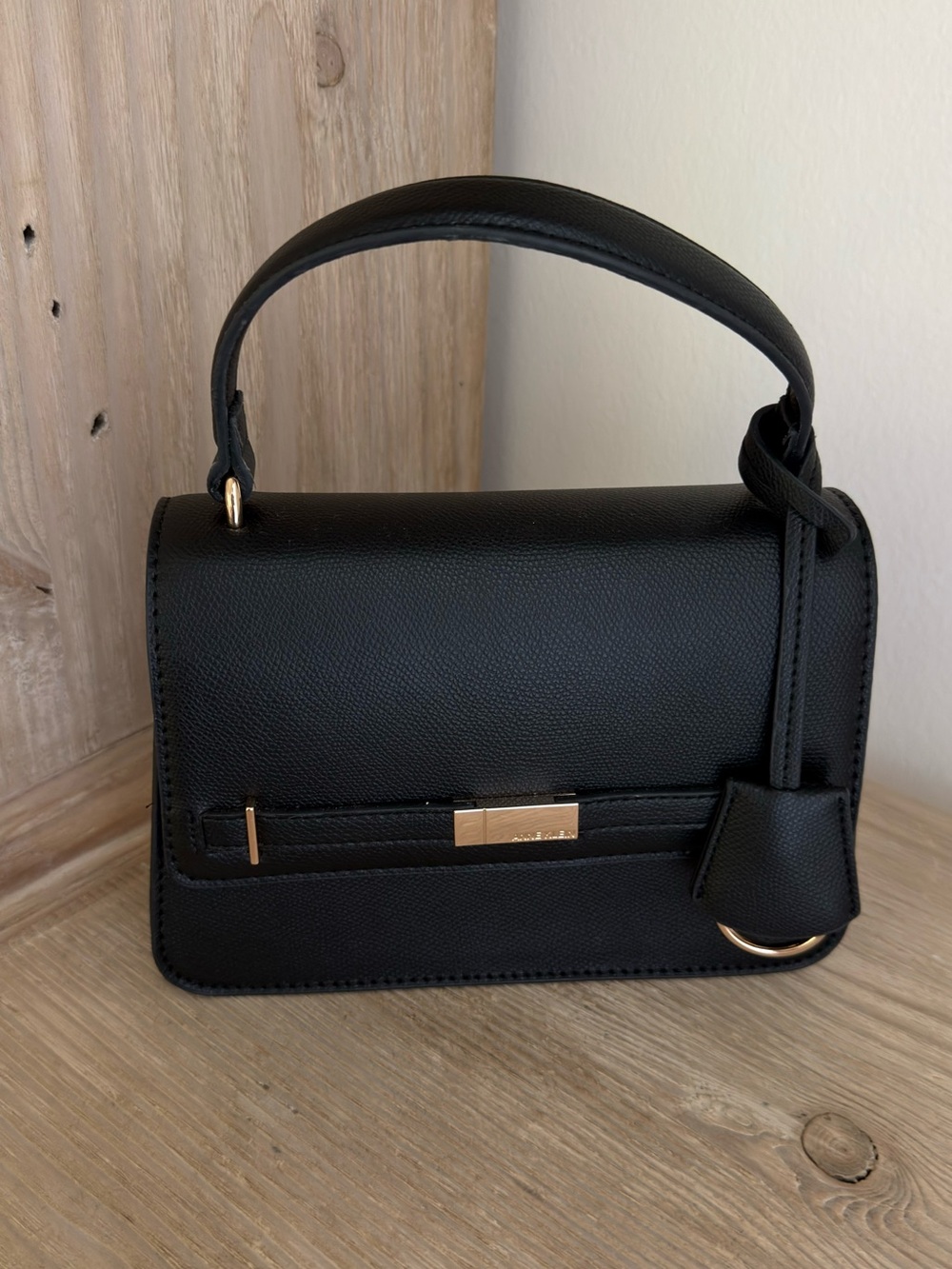 Black flap saddle bag with strap.